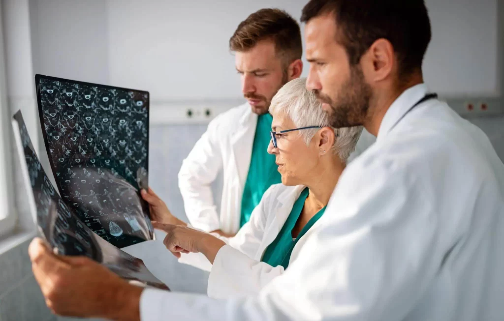 Medical team reviewing imaging scans to plan a patient's regenerative treatment