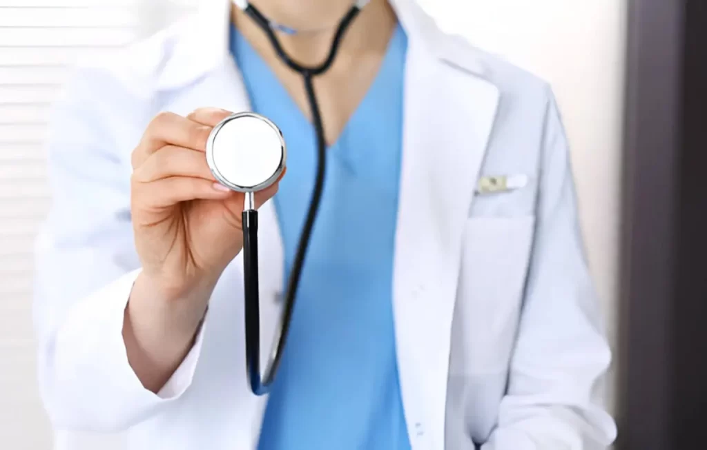 California regenerative medicine doctor in white coat holding a stethoscope during patient consultation