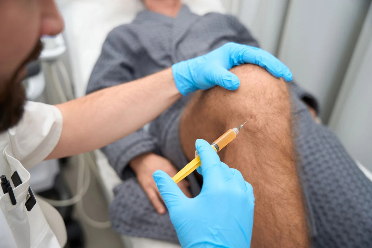 Medical professional administering a cell-free exosome injection into a patient's knee at R3 Stem Cell California.